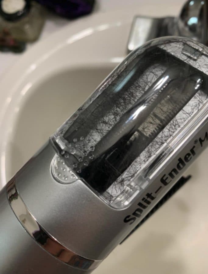 A Split Ender Mini chamber holding removed dark hair